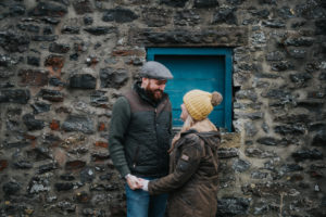 Derbyshire engagement couple in front of stone wall