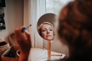 Bride applying make up