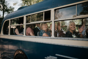 Wedding guests on vintage bus